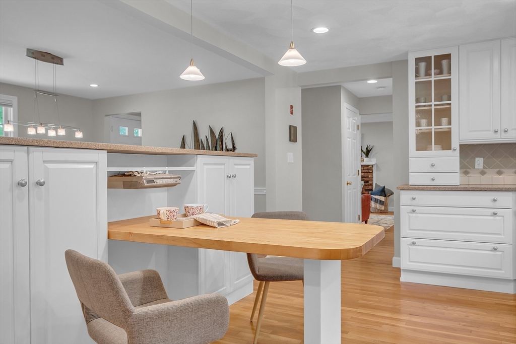 9 Berry Lane Acton, MA 01720 - Photo 5 of 42 a kitchen with a table chairs refrigerator and cabinets
