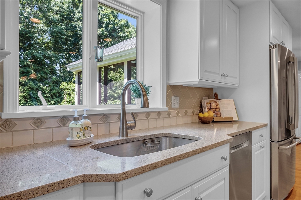 9 Berry Lane Acton, MA 01720 - Photo 6 of 42 a kitchen with stainless steel appliances granite countertop a sink a refrigerator a counter top space and a window