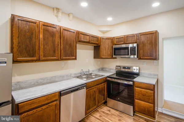 a kitchen that has a sink and a stove top oven