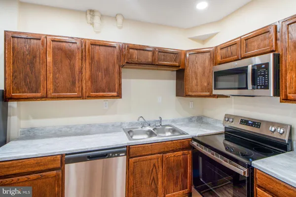 a view of kitchen with refrigerator microwave and stove