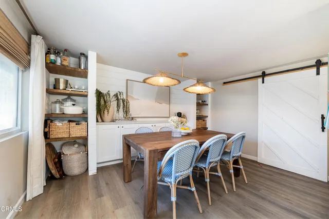 a dining room with furniture and wooden floor