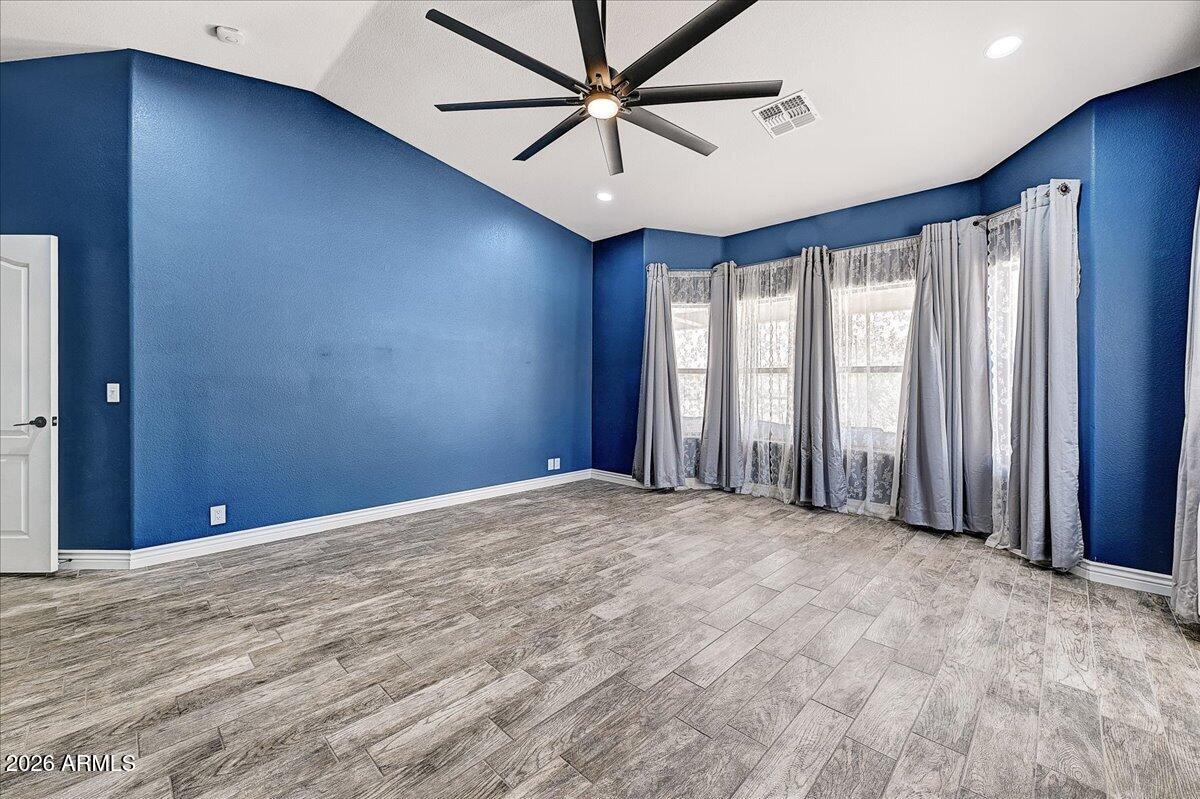 7624 North Citrus Road Waddell, AZ 85355 - Photo 23 of 57 a view of a livingroom with a ceiling fan and window
