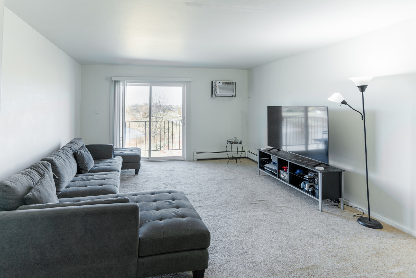 159 West Elk Trail, Unit 357 Carol Stream, IL 60188 - Photo 3 of 10 a living room with furniture and a flat screen tv