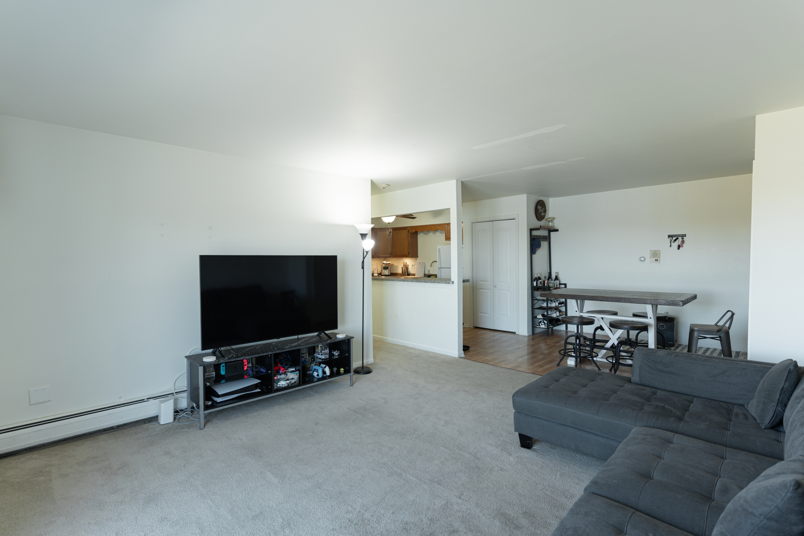 159 West Elk Trail, Unit 357 Carol Stream, IL 60188 - Photo 4 of 10 a living room with furniture and a flat screen tv