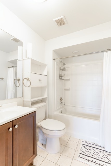 159 West Elk Trail, Unit 357 Carol Stream, IL 60188 - Photo 8 of 10 a bathroom with a granite countertop sink a toilet a mirror and shower