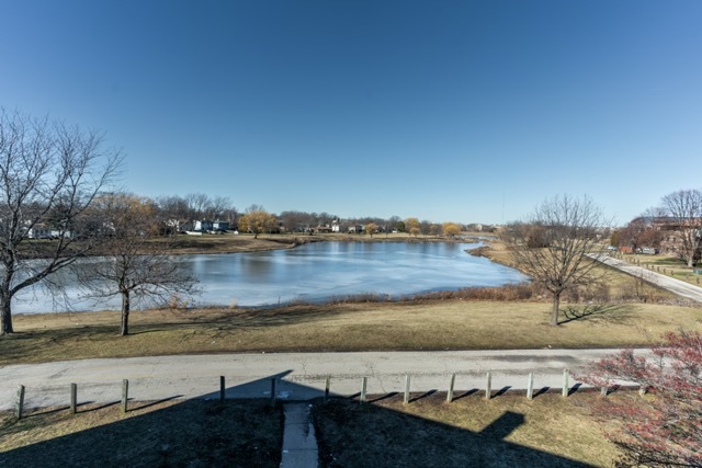 159 West Elk Trail, Unit 357 Carol Stream, IL 60188 - Photo 9 of 10 a view of a lake with a yard