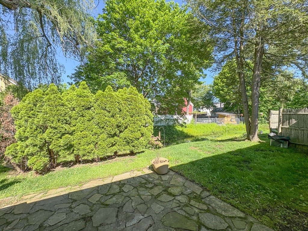 103 Main Street, Unit 10 Pepperell, MA 01463 - Photo 20 of 22 a view of a yard with plants and trees