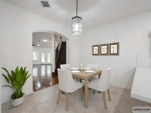 a dining room with furniture and a chandelier
