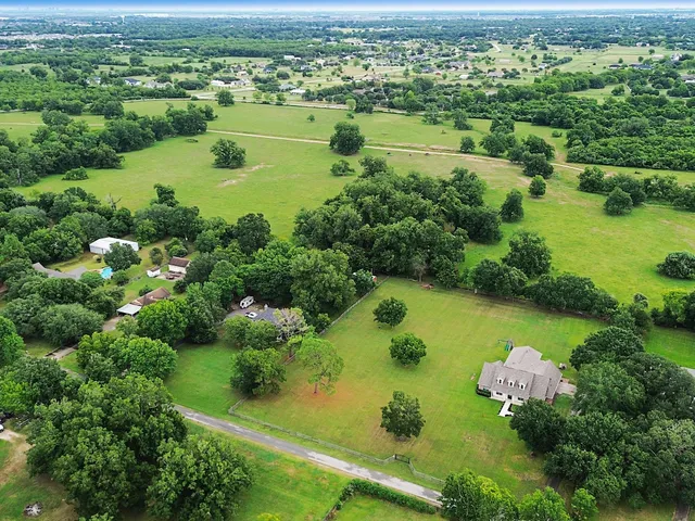 an aerial view of a houses with a lake view