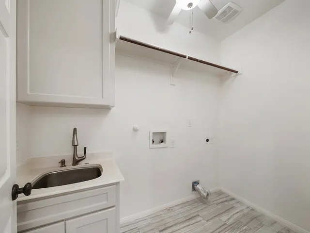 a bathroom with a sink and cabinets