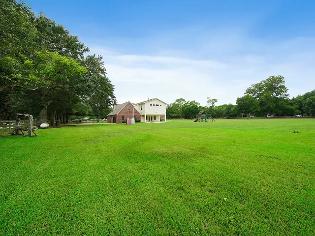 a view of a green field with sitting area