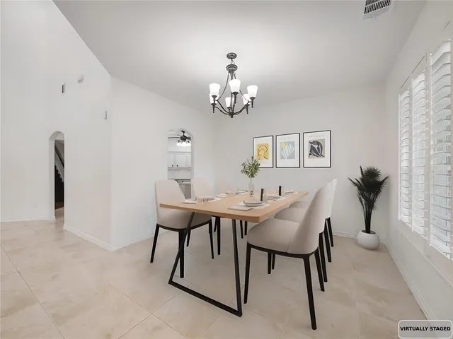 a view of a dining room with furniture and a chandelier