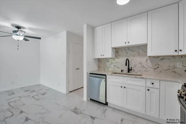 a kitchen with a sink cabinets and appliances