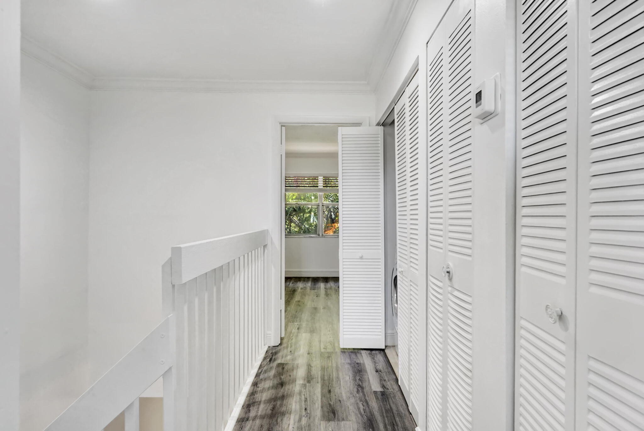6372 Boca Circle Boca Raton, FL 33433 - Photo 17 of 34 a view of a hallway with wooden floor and a bathroom