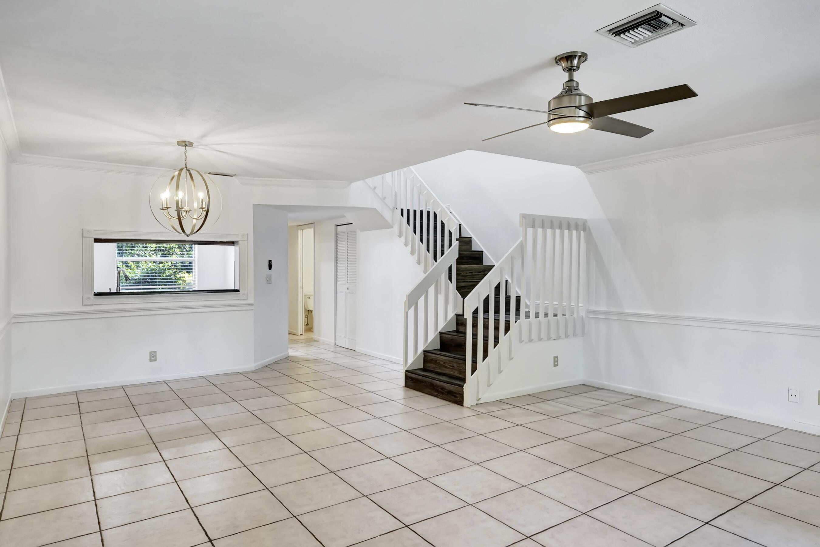 6372 Boca Circle Boca Raton, FL 33433 - Photo 2 of 34 a view of a livingroom with wooden floor and stairs