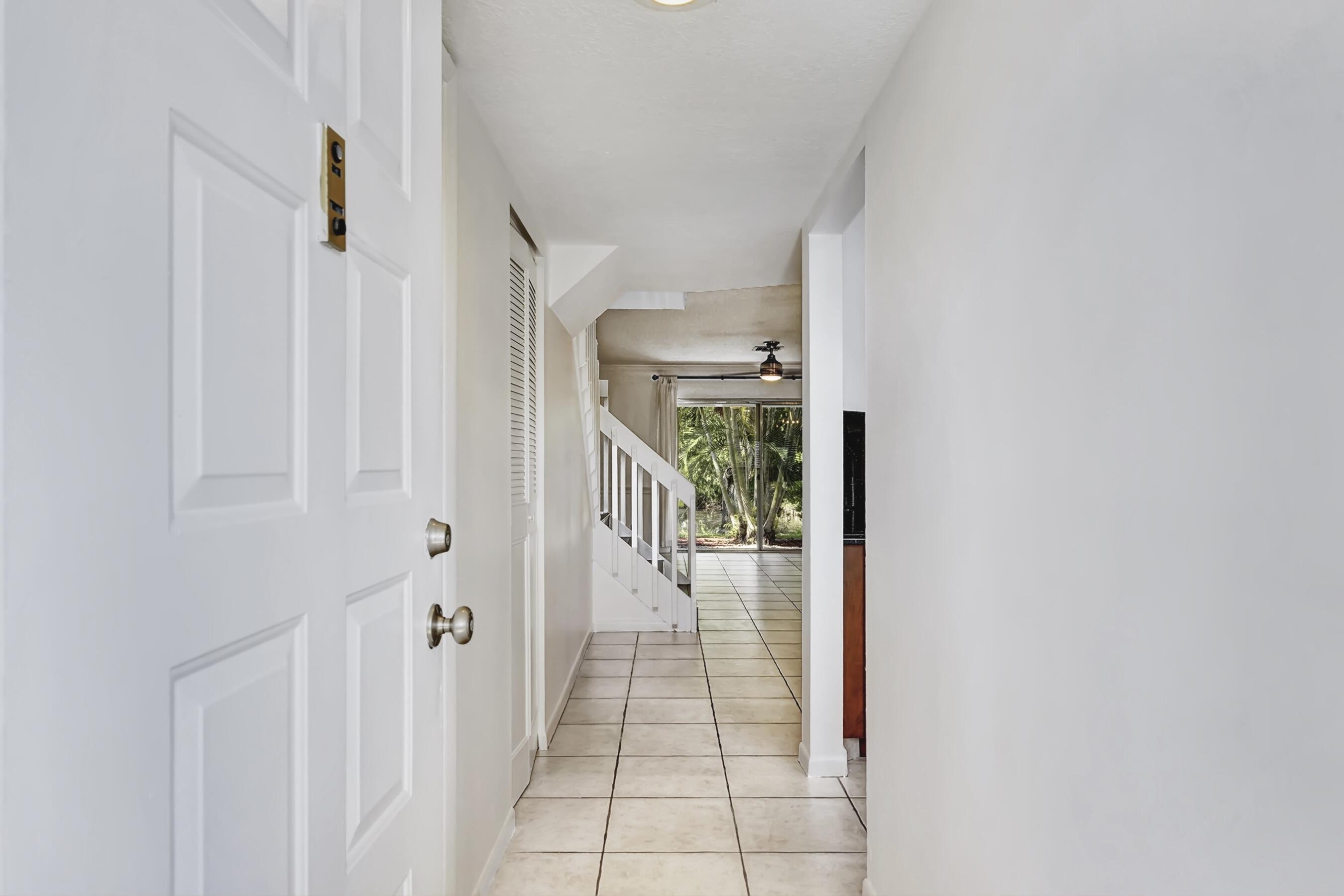 6372 Boca Circle Boca Raton, FL 33433 - Photo 24 of 34 a view of a hallway with white walls and stairs
