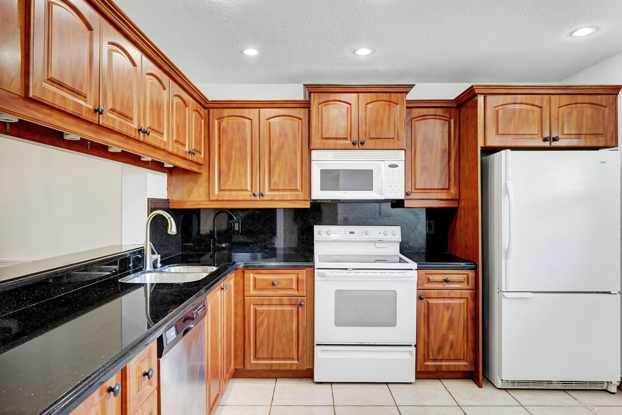 6372 Boca Circle Boca Raton, FL 33433 - Photo 3 of 34 a kitchen with stainless steel appliances granite countertop a refrigerator and a stove top oven