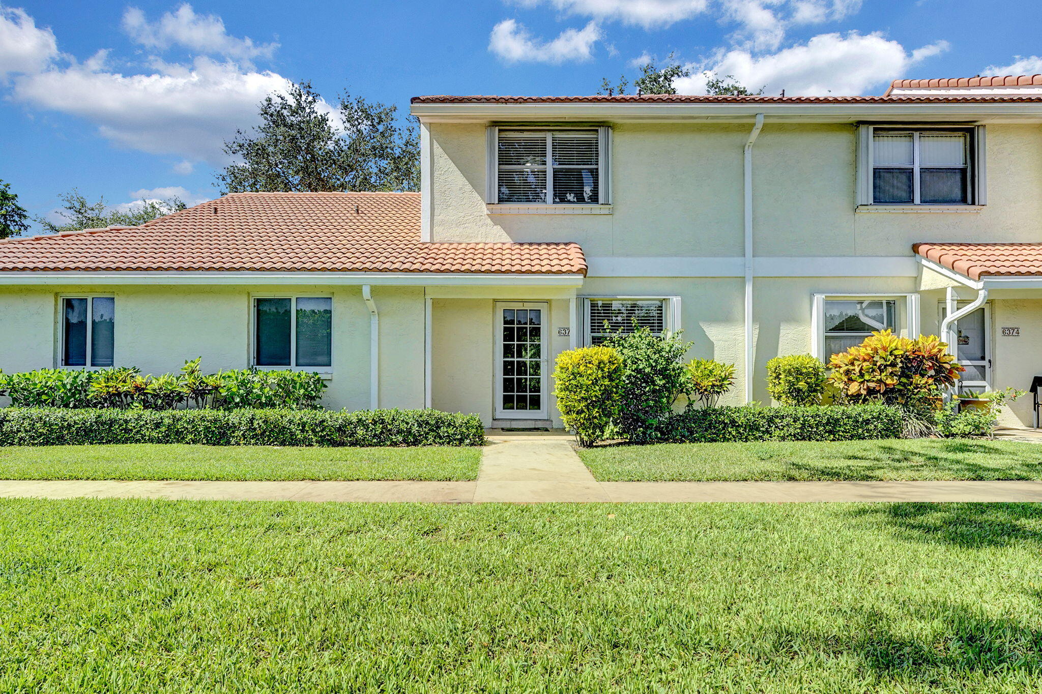 6372 Boca Circle Boca Raton, FL 33433 - Photo 4 of 34 a front view of a house with a yard