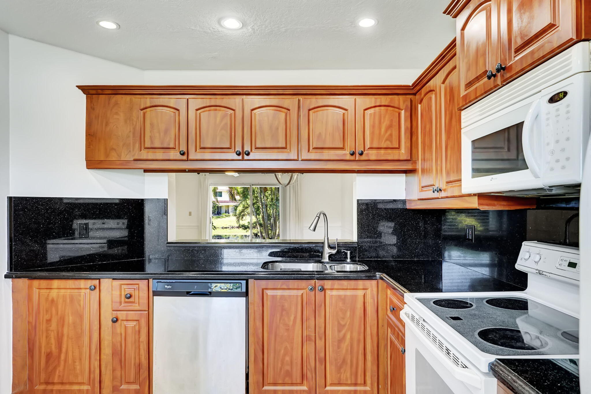 6372 Boca Circle Boca Raton, FL 33433 - Photo 7 of 34 a kitchen with stainless steel appliances granite countertop a stove and a microwave