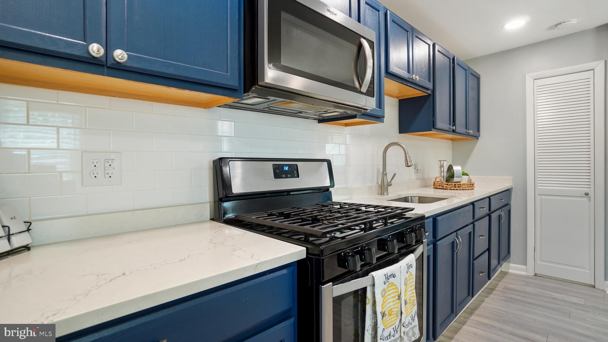 1802 Kitty Hawk Road Baltimore, MD 21221 - Photo 11 of 22 a kitchen with stainless steel appliances granite countertop a stove and a sink