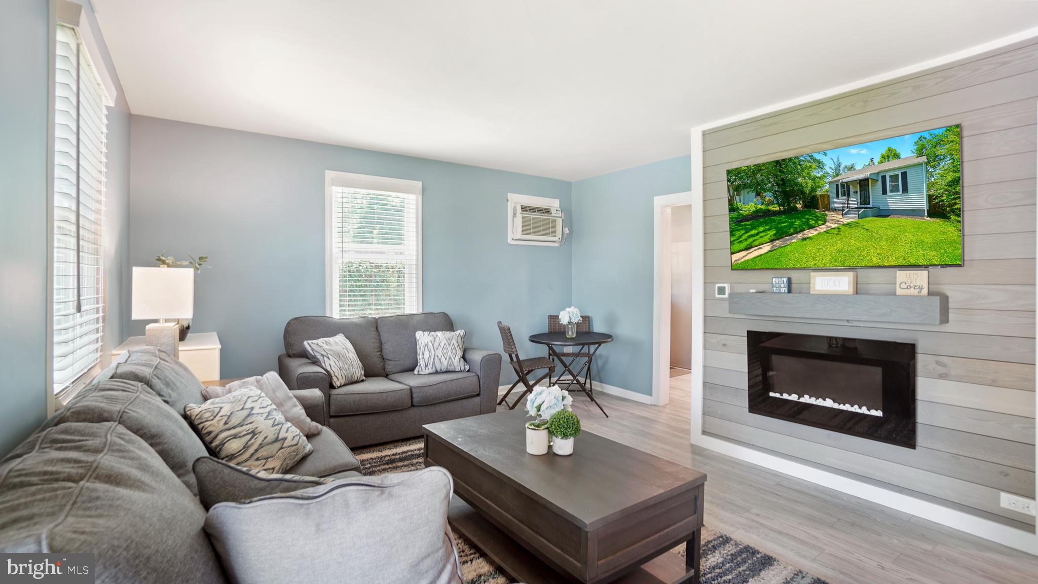 1802 Kitty Hawk Road Baltimore, MD 21221 - Photo 6 of 22 a living room with furniture a flat screen tv and a fireplace