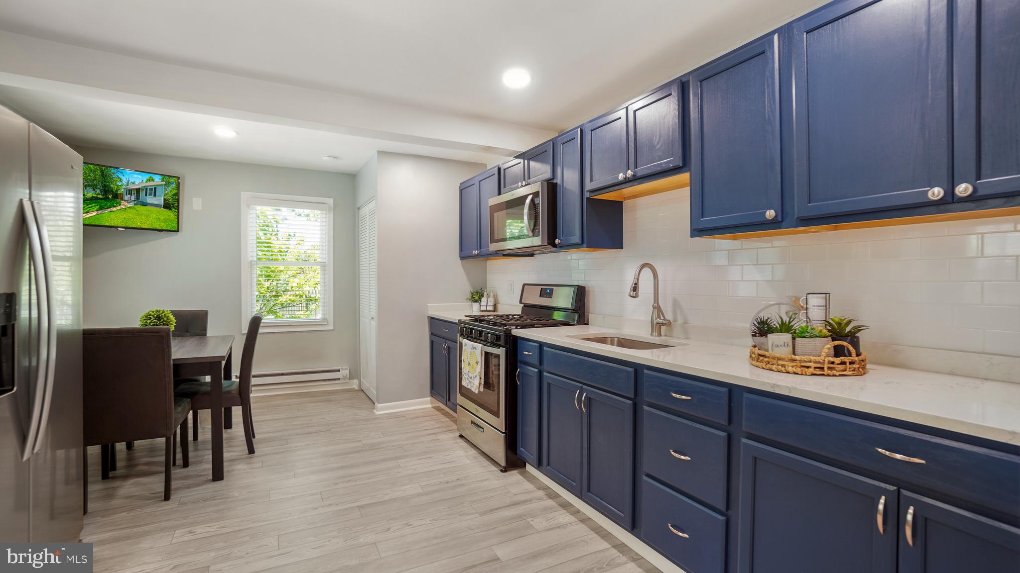 1802 Kitty Hawk Road Baltimore, MD 21221 - Photo 8 of 22 a kitchen with a sink cabinets and window