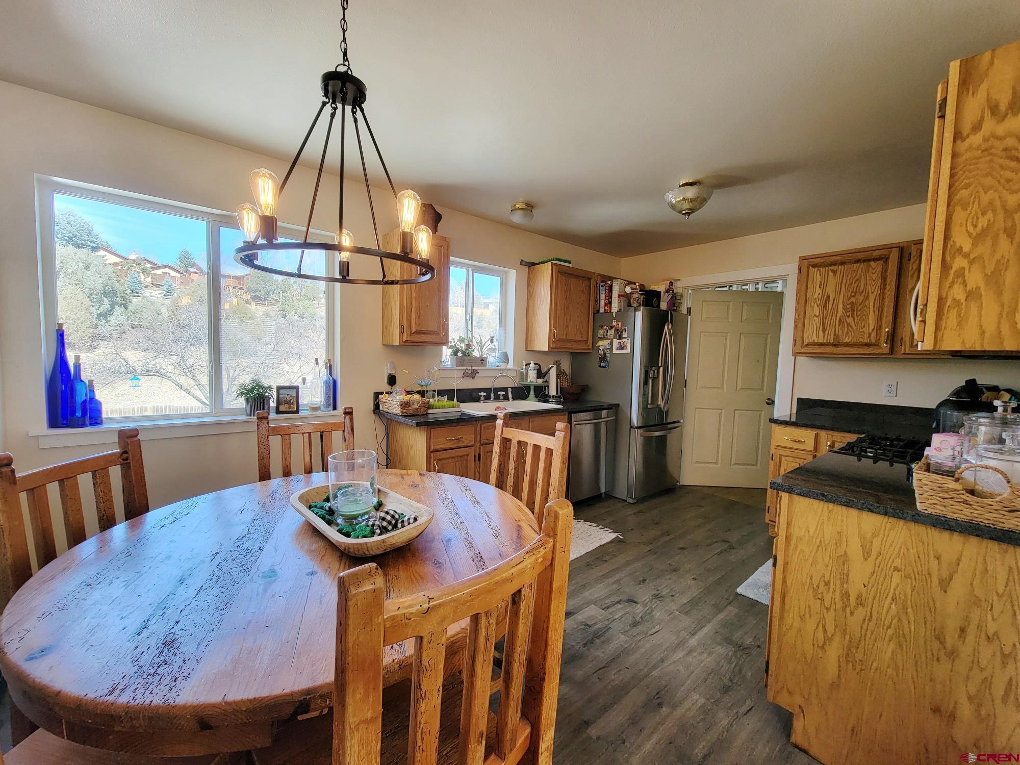 229 Jenkins Ranch Road, Unit A Durango, CO 81301 - Photo 8 of 16 a kitchen with stainless steel appliances granite countertop a sink a stove and a refrigerator