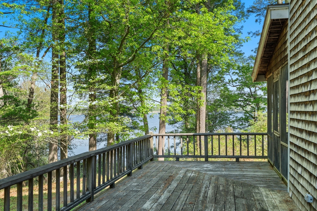 362 Snows Pond Road Rochester, MA 02770 - Photo 27 of 41 a view of a wooden balcony and trees