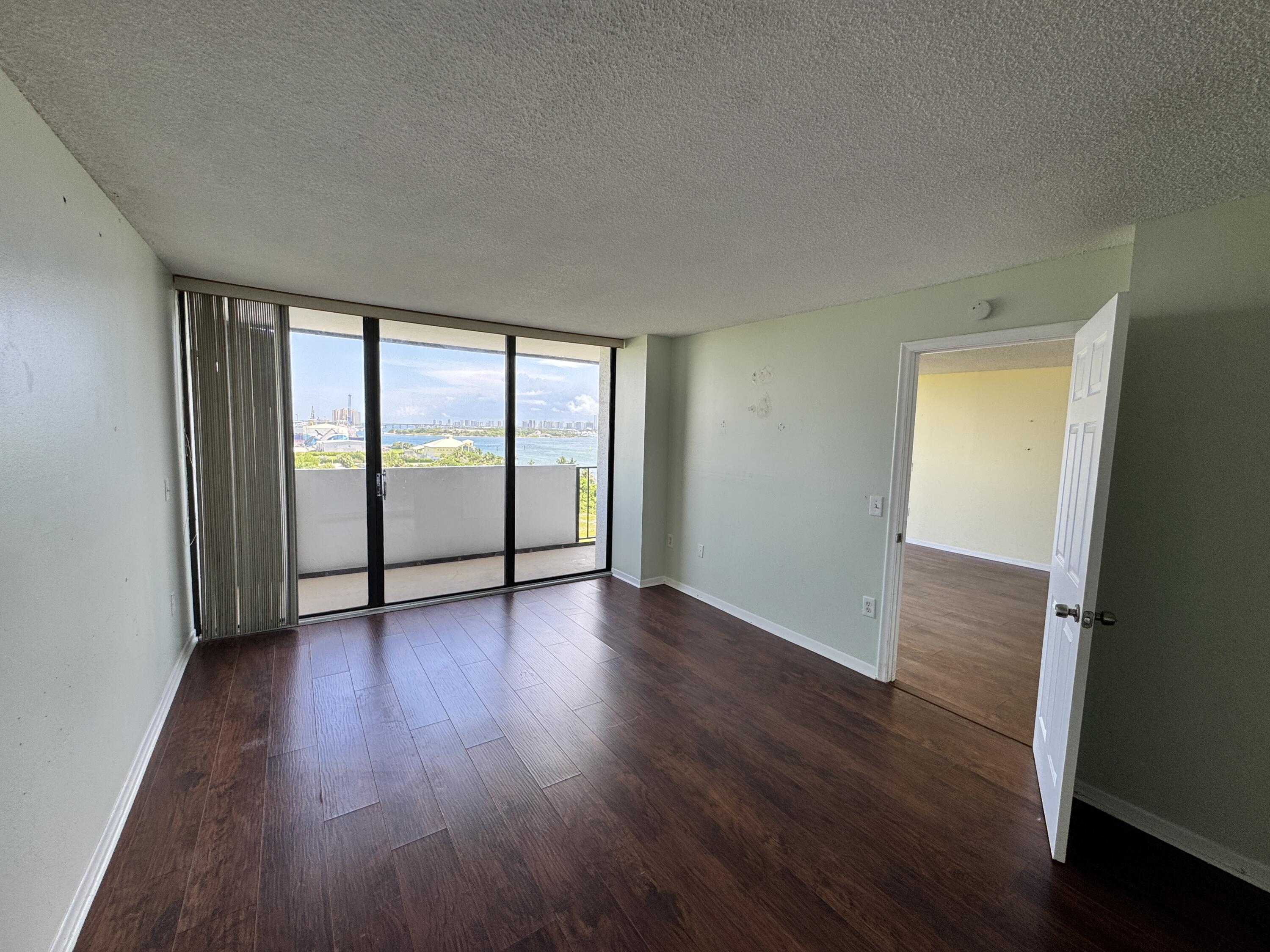 5600 North Flagler Drive, Unit 906 West Palm Beach, FL 33407 - Photo 12 of 18 wooden floor in an empty room with a window