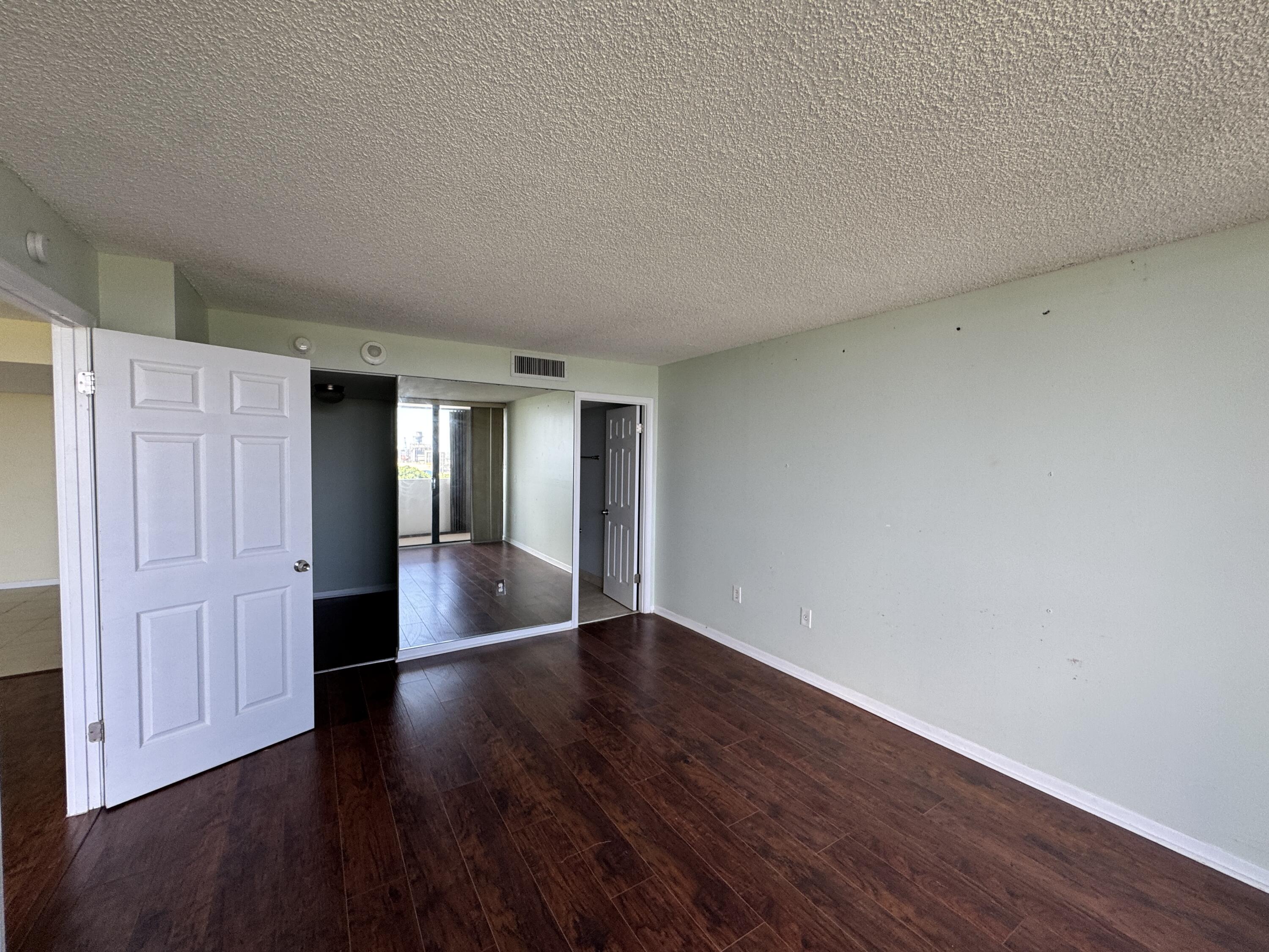 5600 North Flagler Drive, Unit 906 West Palm Beach, FL 33407 - Photo 14 of 18 wooden floor in an empty room