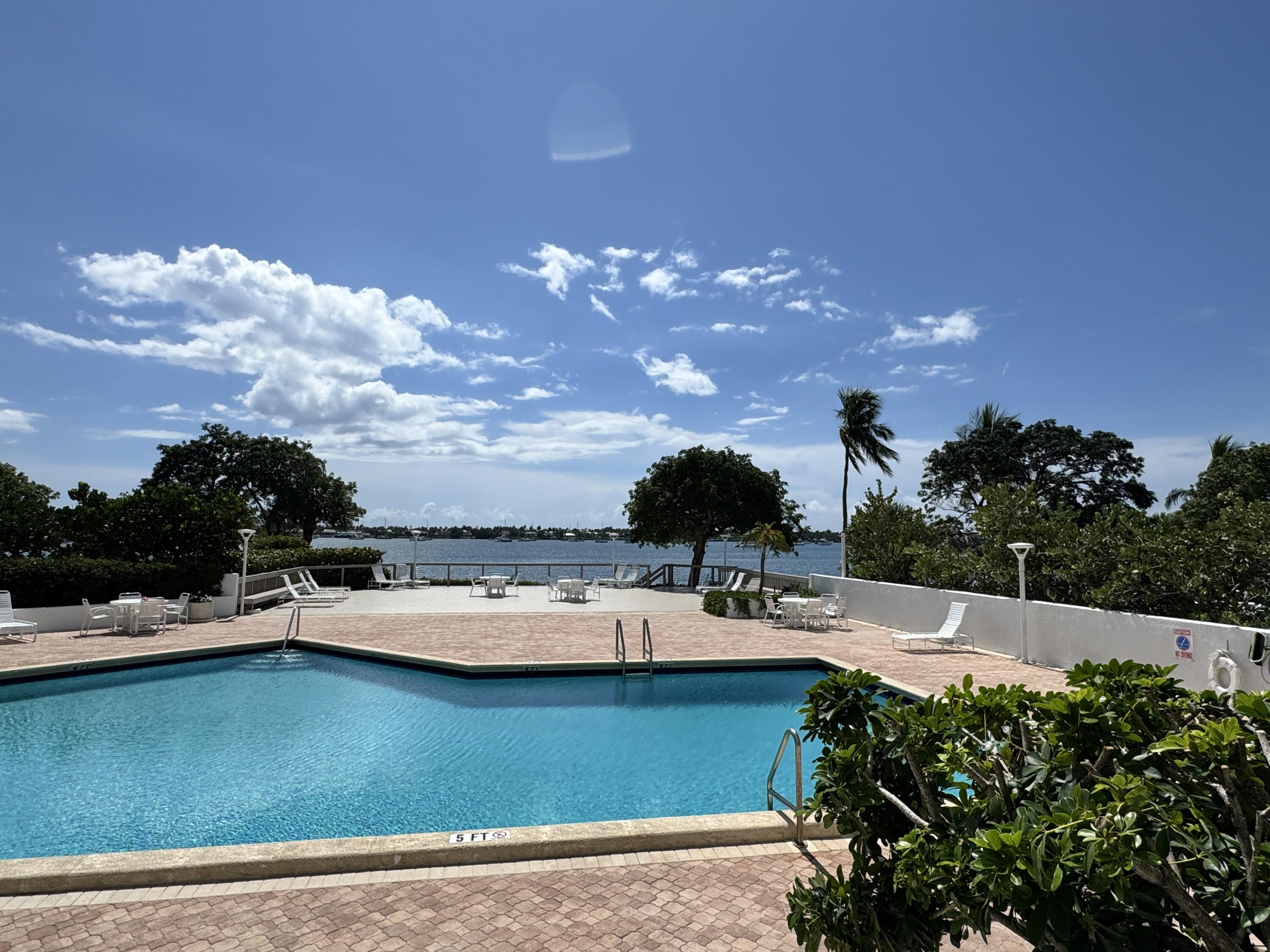 5600 North Flagler Drive, Unit 906 West Palm Beach, FL 33407 - Photo 5 of 18 a view of a swimming pool with outdoor seating
