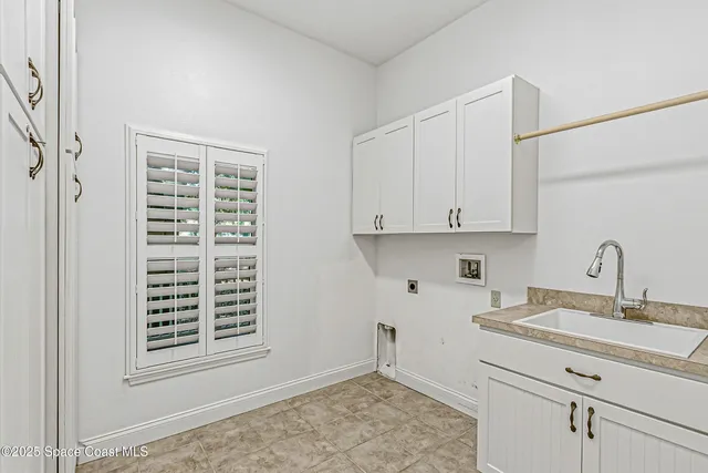 an aerial view of a house with swimming pool and large trees