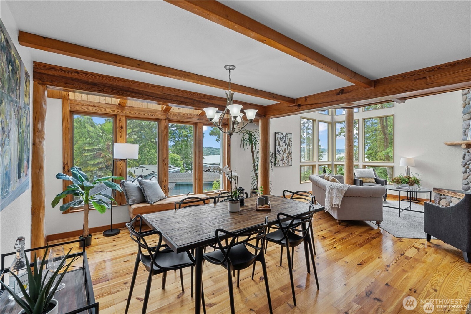8526 East Mercer Way Mercer Island, WA 98040 - Photo 11 of 40 a view of a dining room with furniture large windows and wooden floor