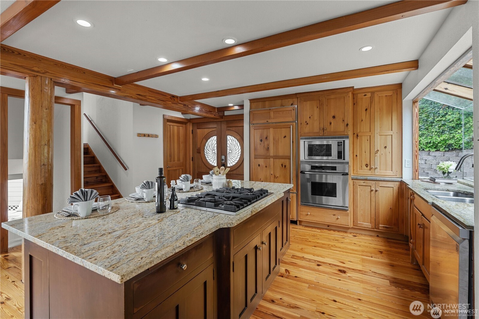 8526 East Mercer Way Mercer Island, WA 98040 - Photo 13 of 40 a kitchen with stainless steel appliances granite countertop a sink and a refrigerator