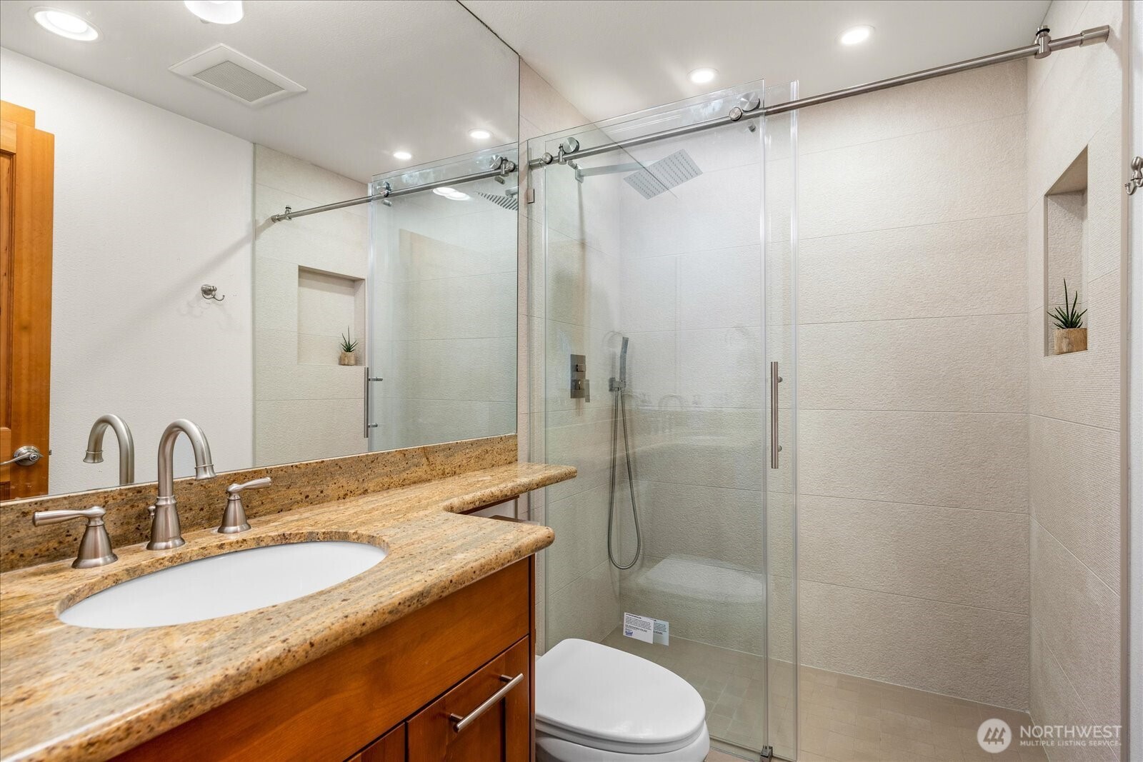8526 East Mercer Way Mercer Island, WA 98040 - Photo 17 of 40 a bathroom with a granite countertop sink toilet and shower
