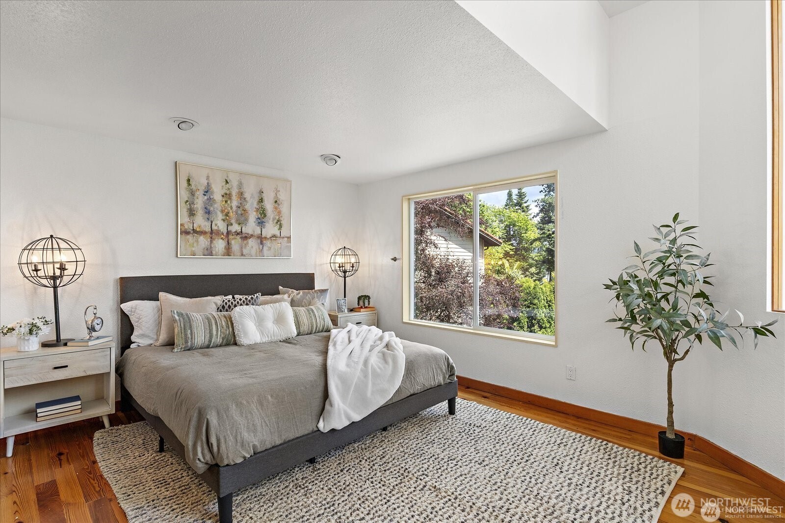 8526 East Mercer Way Mercer Island, WA 98040 - Photo 18 of 40 a bedroom with a bed and a potted plant