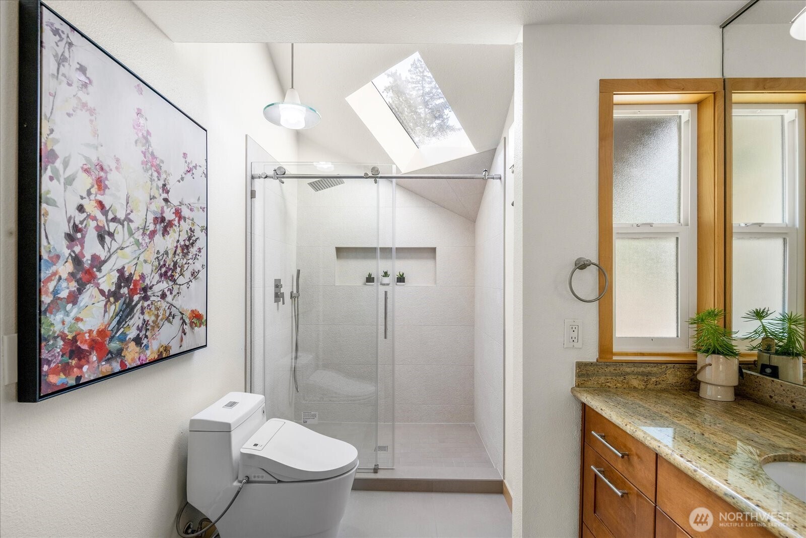 8526 East Mercer Way Mercer Island, WA 98040 - Photo 25 of 40 a bathroom with a granite countertop sink a toilet and a shower