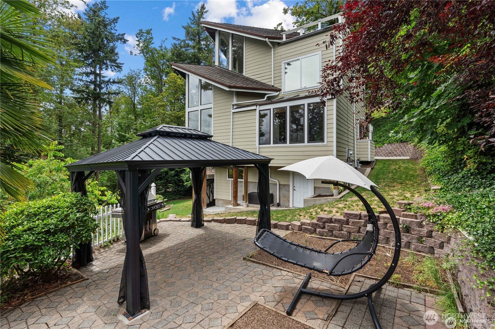 8526 East Mercer Way Mercer Island, WA 98040 - Photo 34 of 40 a view of a patio with table and chairs under an umbrella