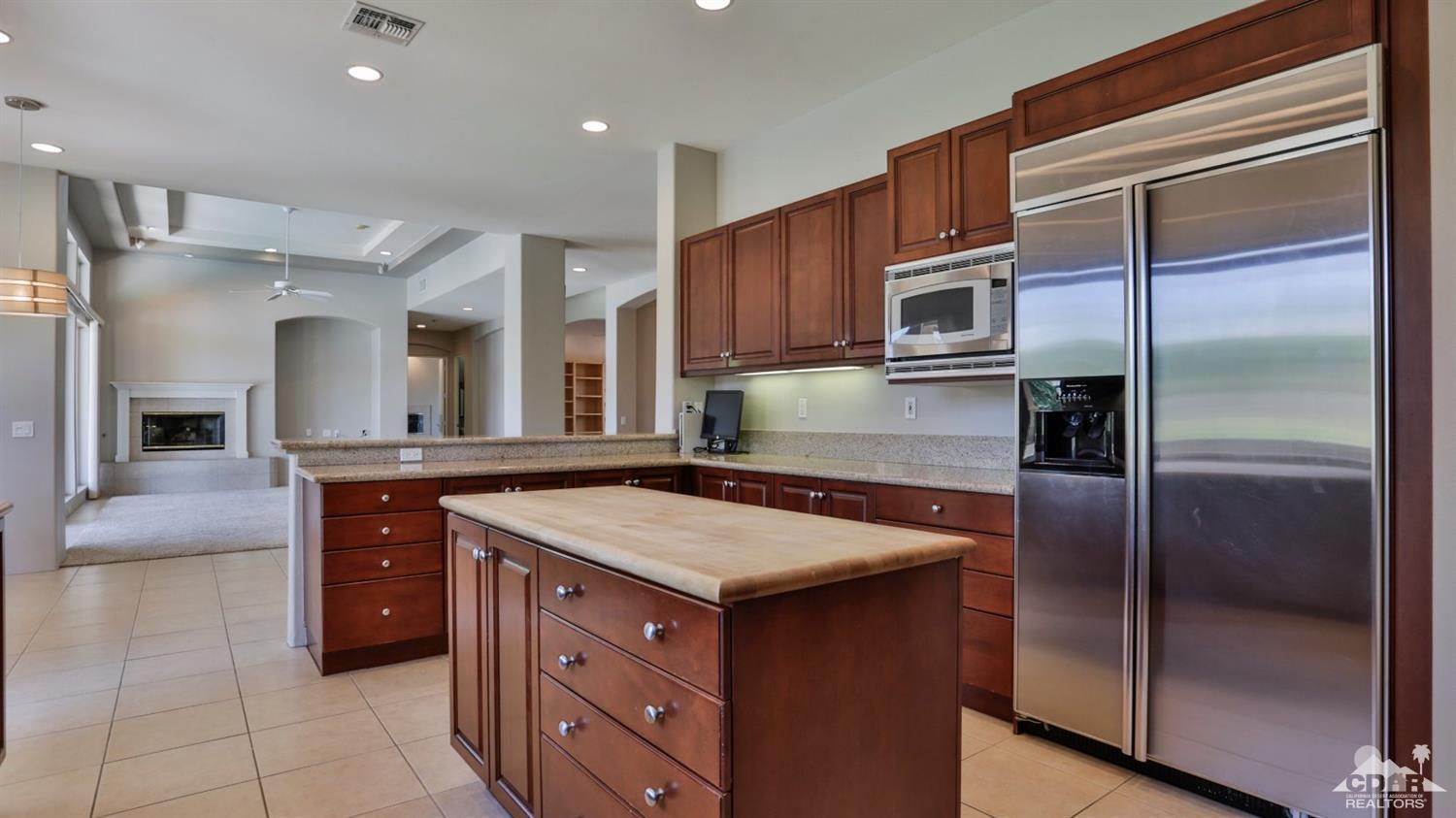 5 University Circle Rancho Mirage, CA 92270 - Photo 11 of 60 a kitchen with a refrigerator and a sink