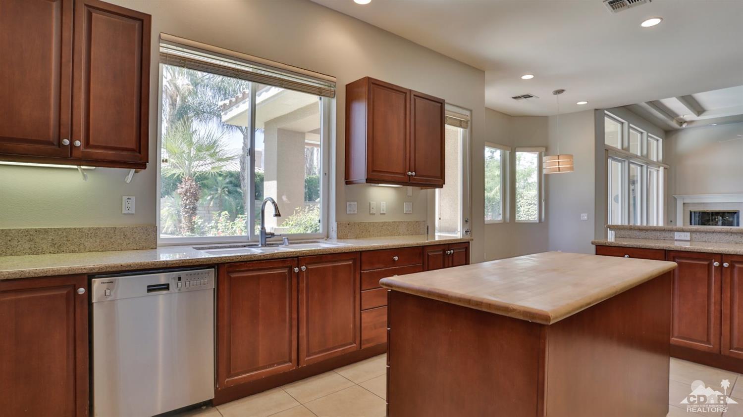 5 University Circle Rancho Mirage, CA 92270 - Photo 12 of 60 a kitchen with granite countertop a sink and a stove