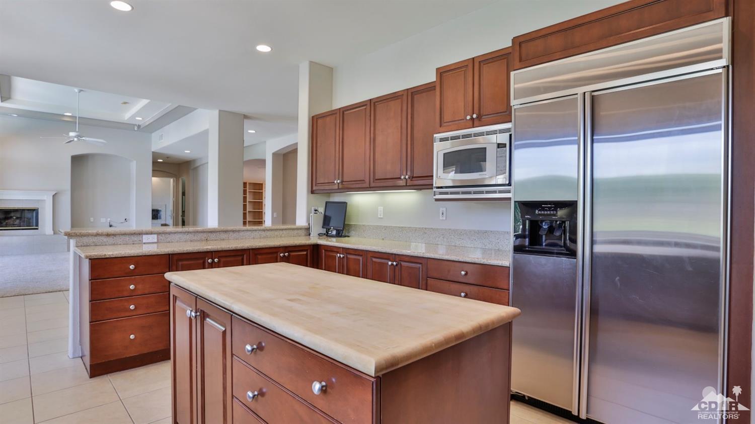 5 University Circle Rancho Mirage, CA 92270 - Photo 14 of 60 a kitchen with a stove a sink and a refrigerator