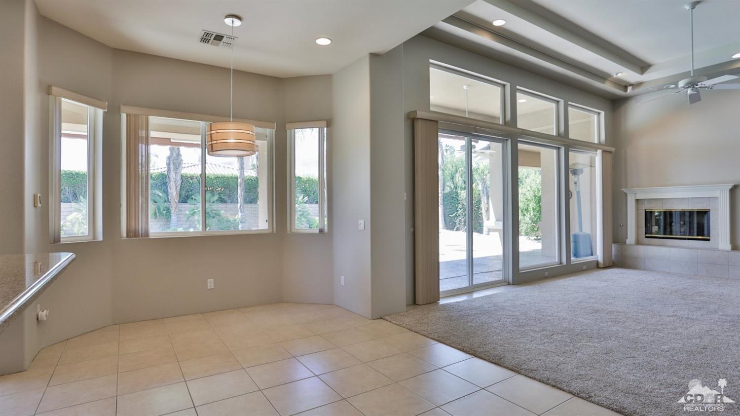 5 University Circle Rancho Mirage, CA 92270 - Photo 17 of 60 a view of an empty room with a fireplace and a window