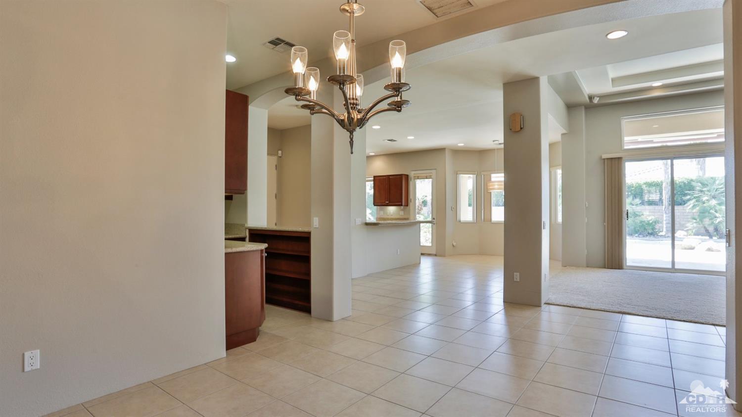5 University Circle Rancho Mirage, CA 92270 - Photo 20 of 60 a view of a hallway with a dining table chairs