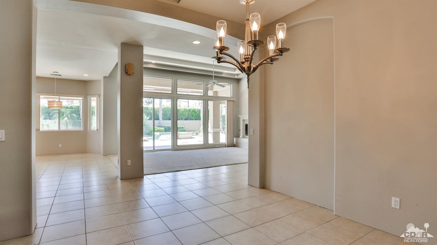 5 University Circle Rancho Mirage, CA 92270 - Photo 21 of 60 a view of a livingroom with a chandelier fan and windows