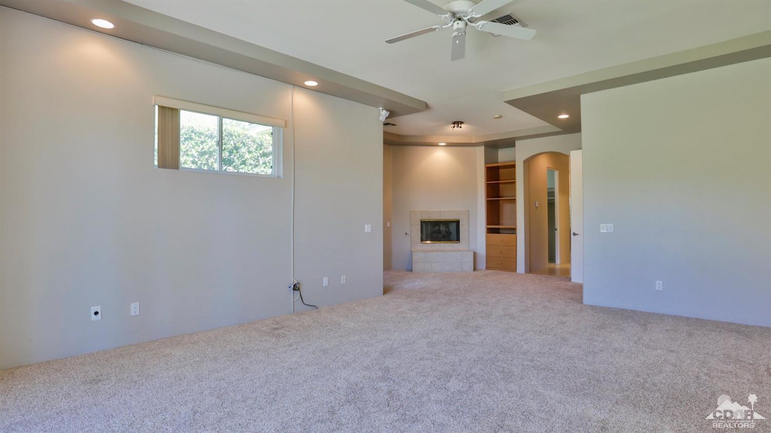 5 University Circle Rancho Mirage, CA 92270 - Photo 25 of 60 en empty room with windows and ceiling fan