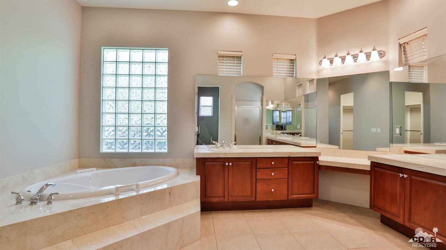5 University Circle Rancho Mirage, CA 92270 - Photo 29 of 60 a spacious bathroom with a tub sink and mirror