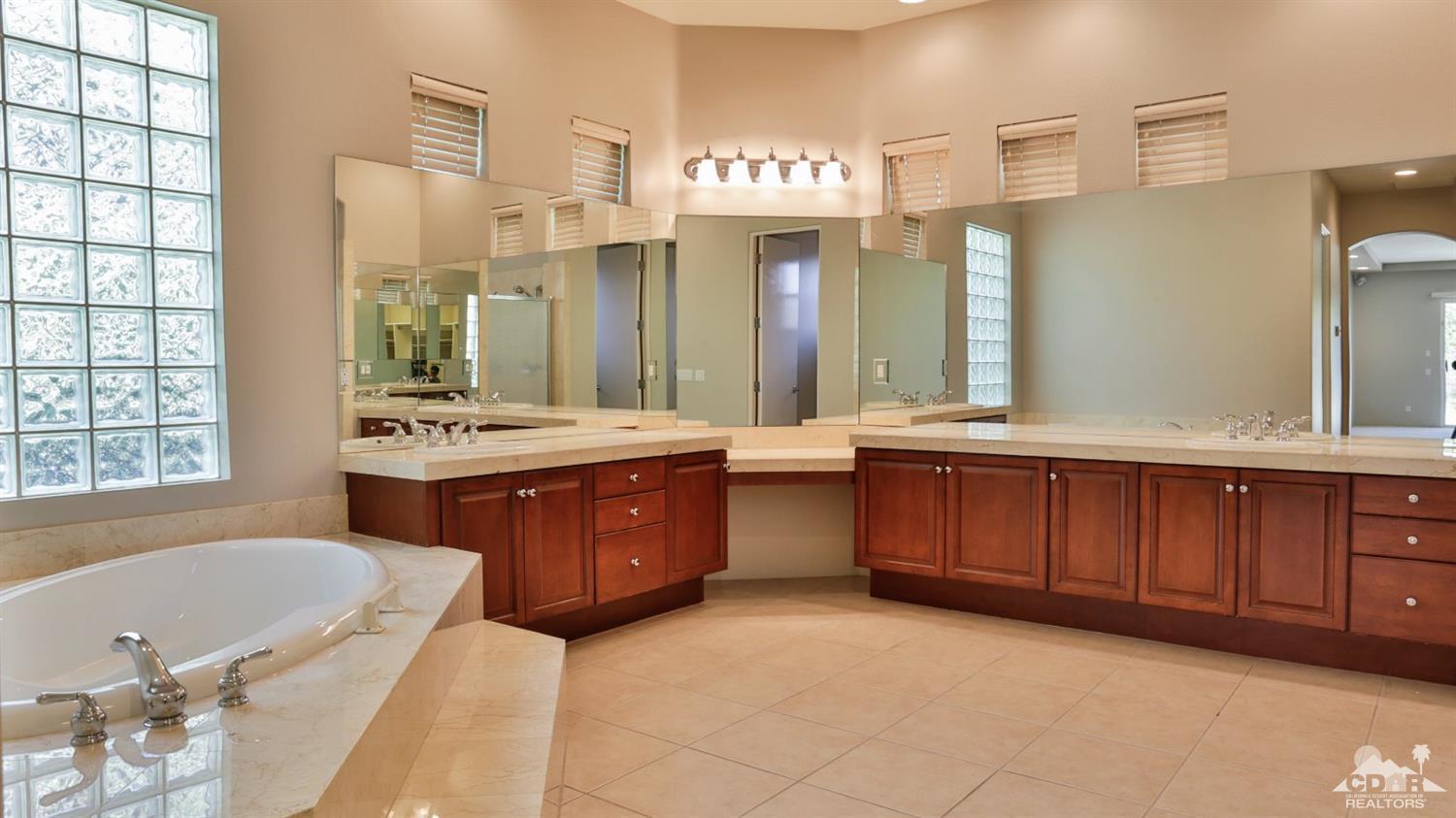 5 University Circle Rancho Mirage, CA 92270 - Photo 30 of 60 a bathroom with a tub sink and mirror
