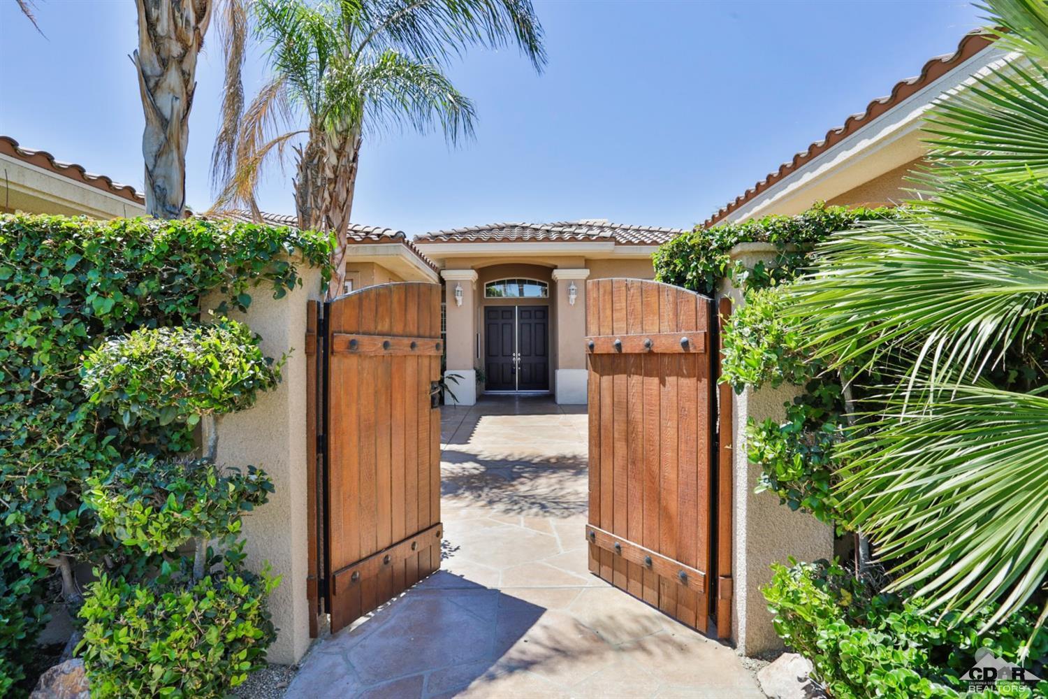 5 University Circle Rancho Mirage, CA 92270 - Photo 4 of 60 a front view of a house with a yard