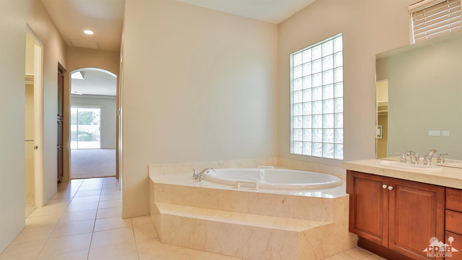 5 University Circle Rancho Mirage, CA 92270 - Photo 31 of 60 a bathroom with a tub sink and a mirror