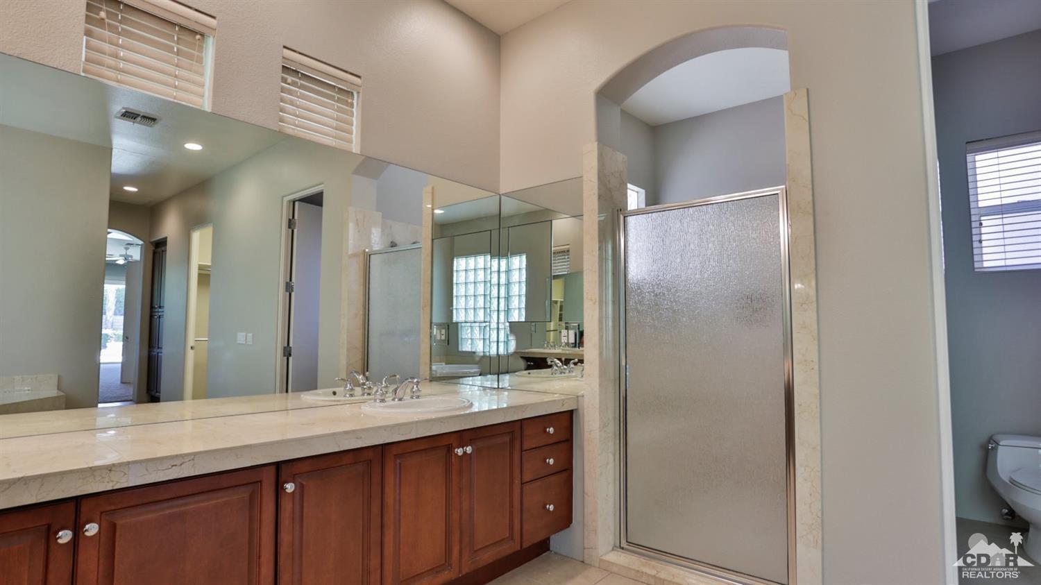 5 University Circle Rancho Mirage, CA 92270 - Photo 32 of 60 a bathroom with a double vanity sink and a mirror